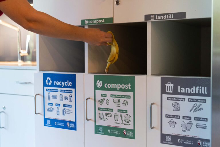 Someone throwing banana peel away in compost bin