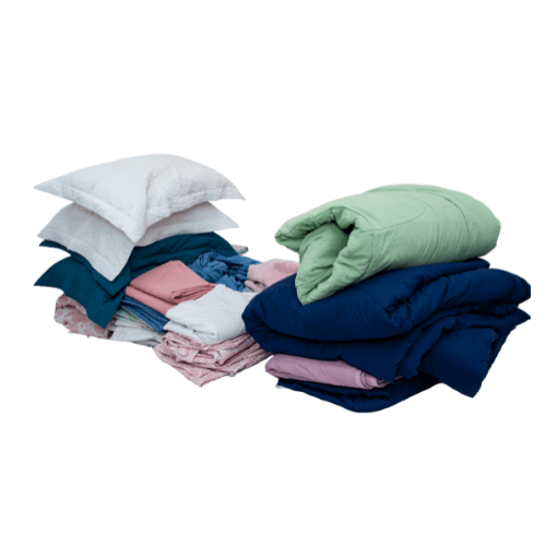 Piles of pillows, blankets, sheets, and towels